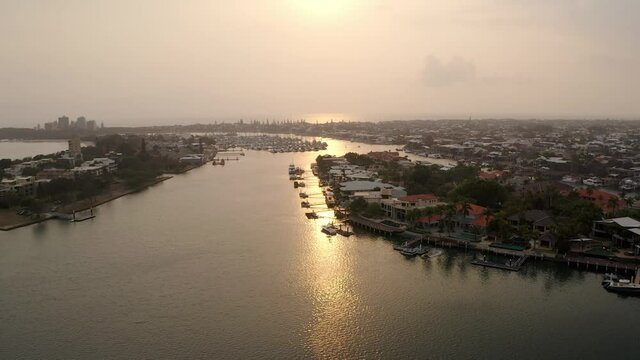 Golden Sunlight Reflection On Waters Of Mooloolah River. Distant View Of Mooloolaba Marina In QLD, Australia. aerial