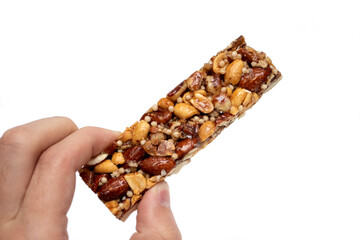 Hand holding nuts bar isolated on white background