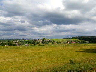 Obraz premium Beautiful summer rural landscape, field, hills, village
