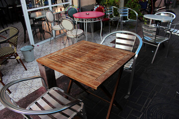 Empty tables on the veranda outside a cafe in the Carmel Market area in Tel Aviv, Israel. Tables and cafes before Shabbat.