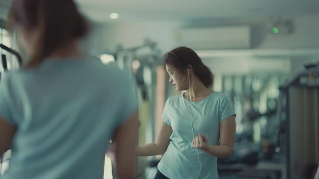 Asian cute girl She is practicing dancing to the rhythm of her favorite song. In front of the mirror at the fitness center, 4k resolution.