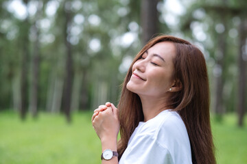 Portrait image of a beautiful asian woman standing in the park