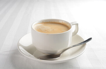 a cup of hot cafe coffee with fresh milk on white background halal beverage menu