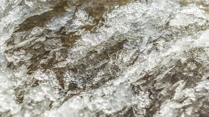 The first ice on the bank of a muddy reservoir in winter. Background for design.