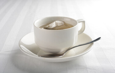 a cup of hot green tea leaf in bag on white background halal beverage menu
