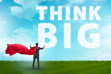 Think big concept with businessman superhero