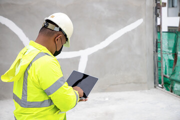 construction engineer working consulting.Asian construction engineer.construction engineer are consulting work using a computer to work