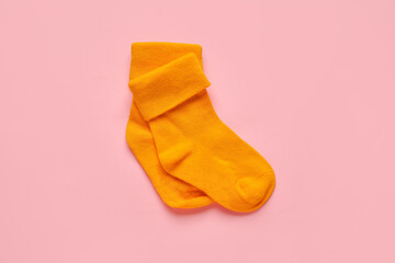 Baby socks on color background