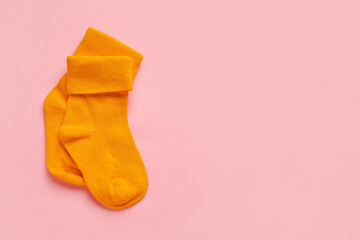 Baby socks on color background