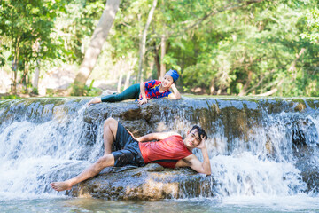 Happy Father with daughter enjoy the waterfall. Traveling nature near a beautiful waterfall at Chet Sao Noi waterfall National Park