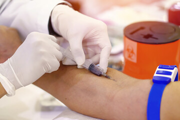Nurse collecting a blood from patient in hospital