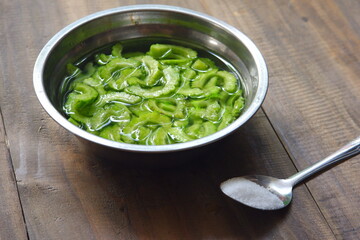 sliced bitter gourd soaked in salt water