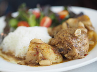 Massaman Curry With Chicken white rice, food in white plate on table