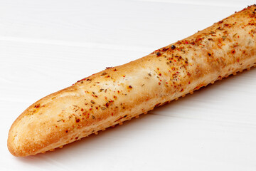 Fresh baguette bread on white wooden table