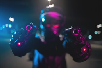 Obraz na płótnie Canvas A motorbiker with a guns in the neon lights. Cyberpunk rider.