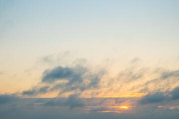 beautiful orange sunrise through the clouds, morning sun in the mountains.