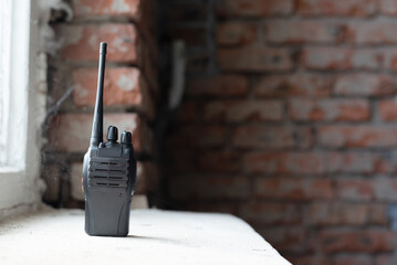 A walkie talkie radio station on the windowsill background.