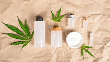 Fototapeta na wymiar marijuana cosmetics and cream with cbd and THC extract on hemp paper