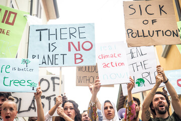 Public demonstration on the street against global warming and pollution. Group of multiethnic...