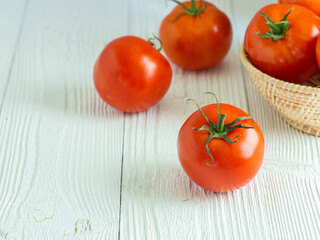 Focus tomato  on white wood table, Copy space for word. Healthy food in morning concept. Verticle picture.