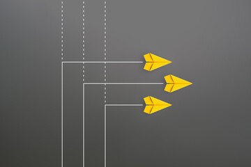New normal concept with Group of yellow paper planes in new direction on gray background - obrazy, fototapety, plakaty