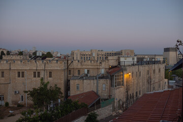 Fototapeta na wymiar Early morning in the Jerusalem. Sunrise time. City view. Old buildings. Clouds on the sky