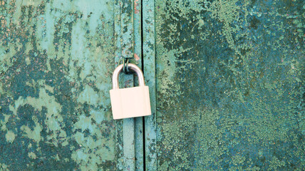 background of very old metal rusty green garage door with handle and barn lock