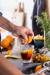 Mixologist making refreshing cocktail with vermouth at home