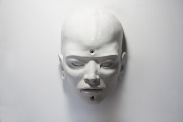 Asian white face. Beautiful white on white sculpture. Head and face with androgynous features. Traditional decorative statue