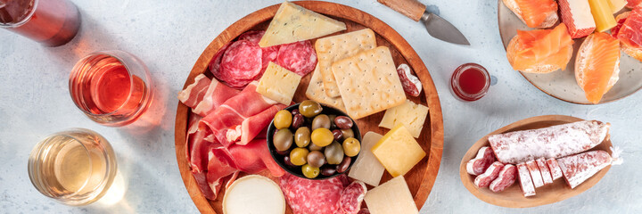 Italian antipasti or Spanish tapas panorama. Gourmet charcuterie and cheese plate, shot from the...