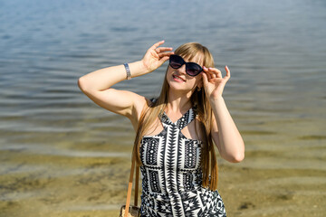 pretty woman in dress near lake, summer time