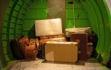 Obraz na płótnie Canvas Old luggage and suit cases waiting in the back of the plane