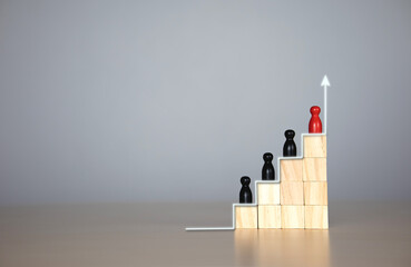 wooden doll in a hierarchy of wooden blocks. The concept of raising the level of individuals in the...