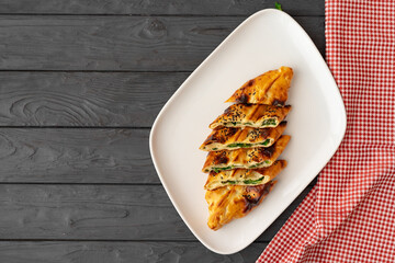 Baked homemade flatbread on wooden background close up
