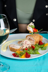 Chicken cordon bleu schnitzel, meat wrapped around ham and cheese