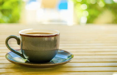 Obraz premium Cup of coffee on table at hotel resort private terrace, morning coffee on vacation.