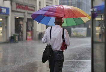 Man walking with umbrella in the rain in Bergamo, Italy.