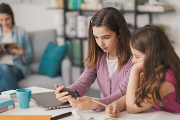 Girls using a smartphone together