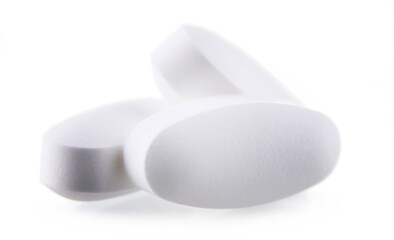 Composition with pharmaceutical drug pills over white background