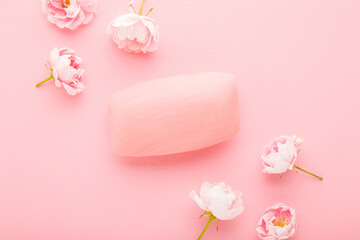 Natural hand soap and beautiful roses on light pink table background. Pastel color. Care about...