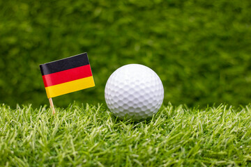 Golf ball with German flag are on green grass