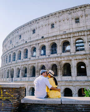 Young Couple Mid Age Asian Woman And European Man On A City Trip In Rome Italy Europe, Colosseum Coliseum Building In Rome, Italy