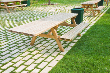 Wooden picnic table on a green meadow in a public park