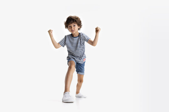 Portrait of little preschool boy posing isolated over white studio background.