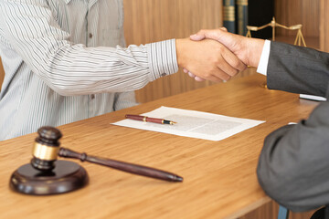 Female lawyer handshake with client. Business partnership meeting successful concept.