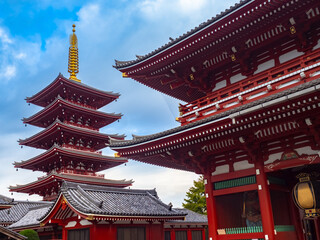 Fototapeta na wymiar Buddhist temple in Tokyo. Japanese pagoda. Asakusa Temple Pagoda. Architecture of Asakusa area in Tokyo. Sensoji Church in Japan. Buddhist sights of Japan. Tokyo in sunny weather.