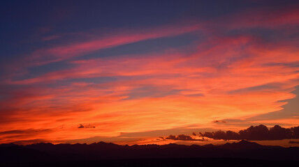 colorful sunset over long's peak and the front range of the colorado rocky mountains, as seen from broomfield, colorado 