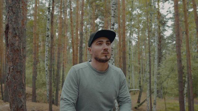 Portrait of Hicker in the Forest Among the Trees and Enjoys the Beauty of the Forest. Portrait of a Male Traveler in Lesovaya. Lost Man in the Forest. Tourist. Hicker in the Woods at Rest