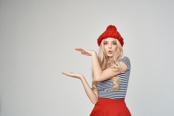 woman in a red hat gesturing with her hands Red skirt fashion