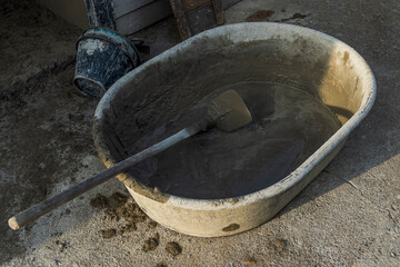 Empty mixing bucket for construction, Cement mixing equipment and wooden handle hoe steel on site